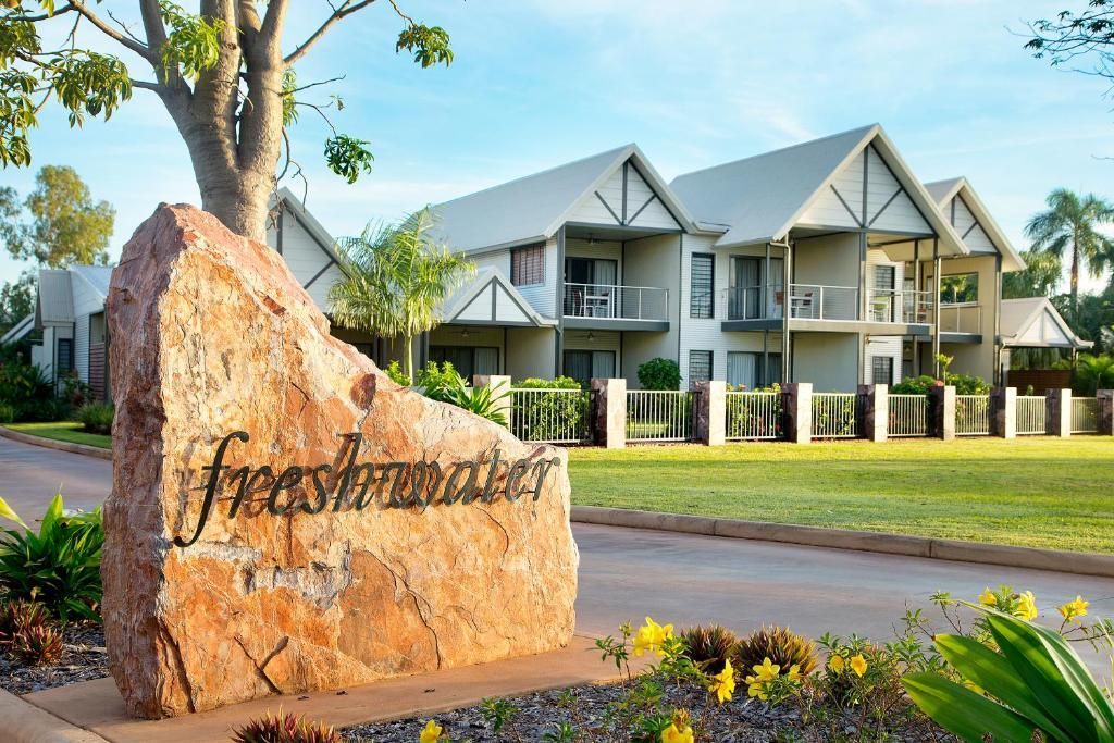A large rock in front of a building that says freshwater