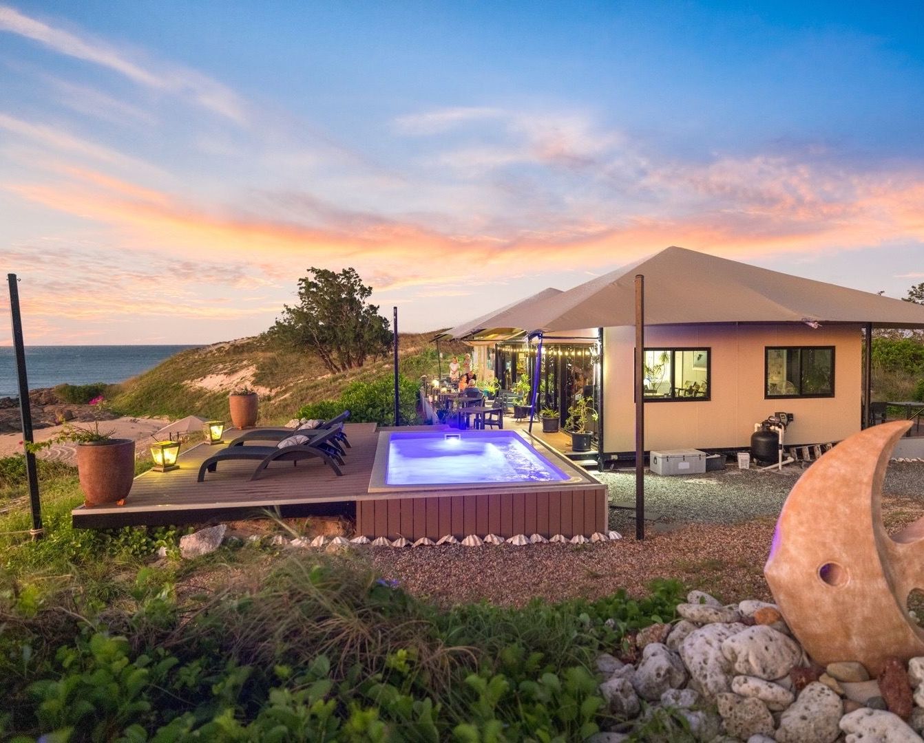 A house with a swimming pool in front of it.