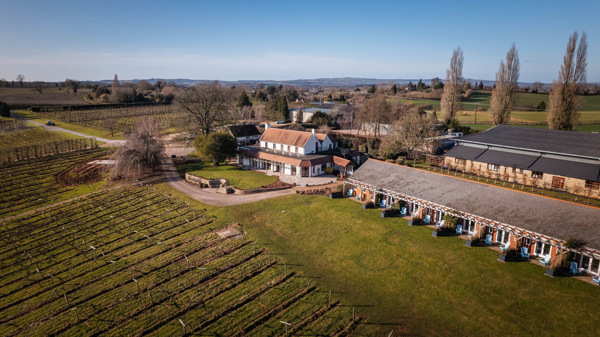 a bedroom with a large bed and a view of a vineyard