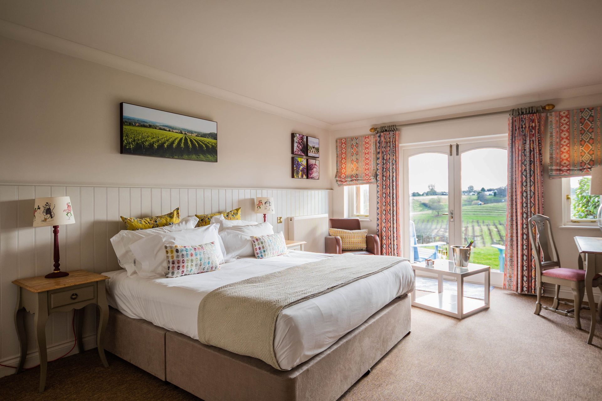 Elegant double bed in a deluxe room at Three Choirs with stunning vineyard views – ideal for a romantic retreat