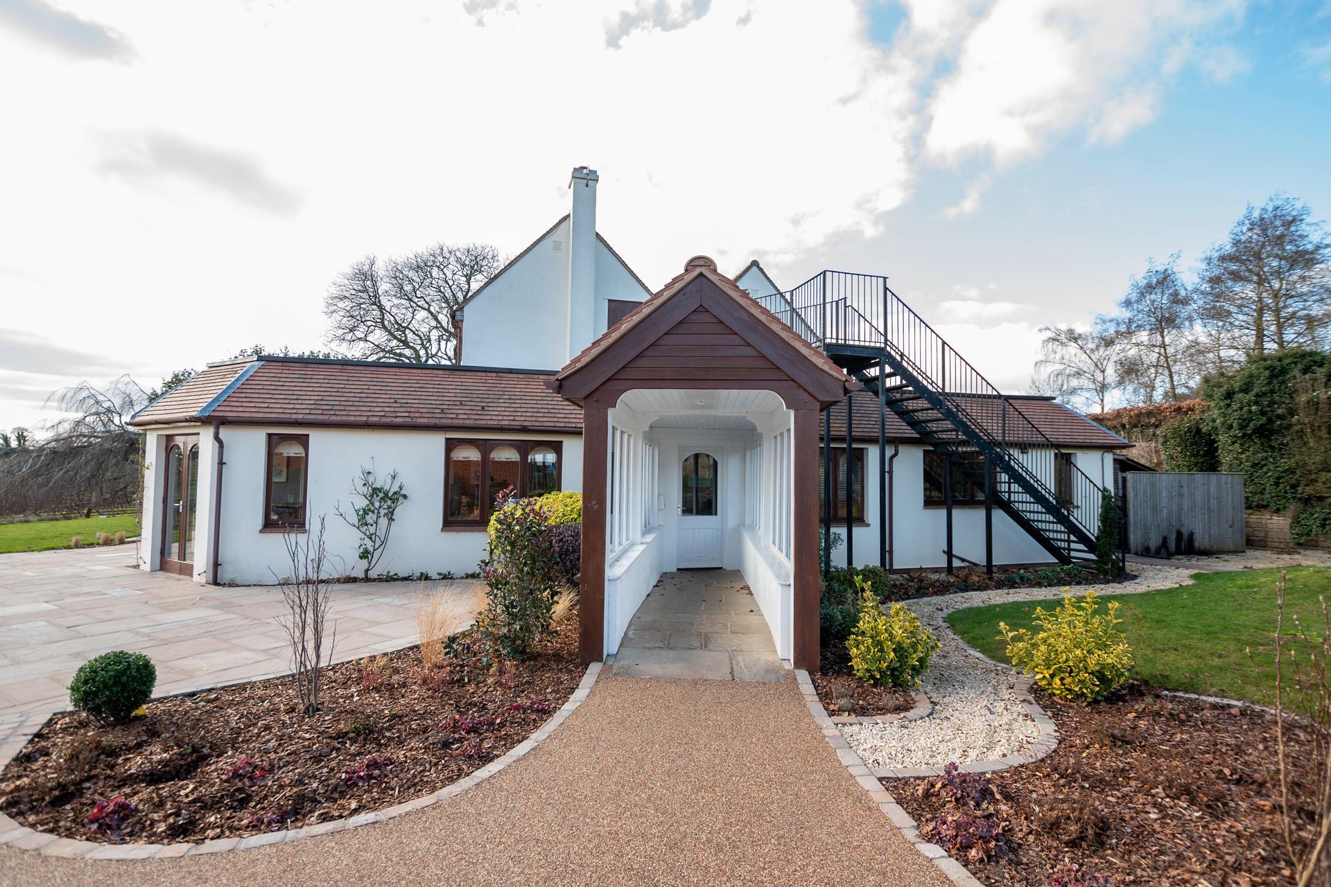 a white house with a walkway leading to it