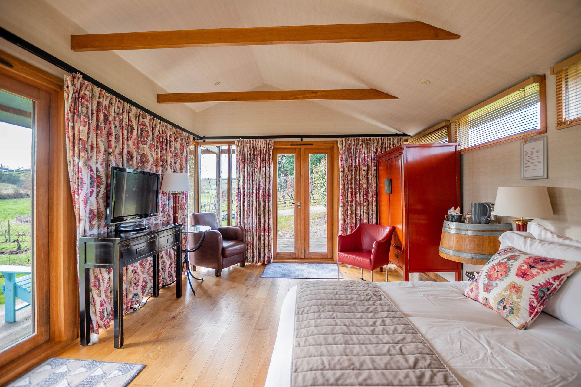 a bedroom with a large bed and a television