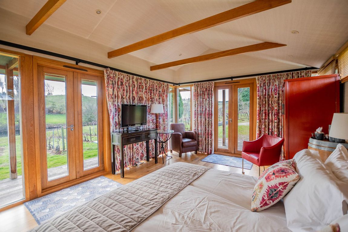 a bedroom with a bed a chair and a table