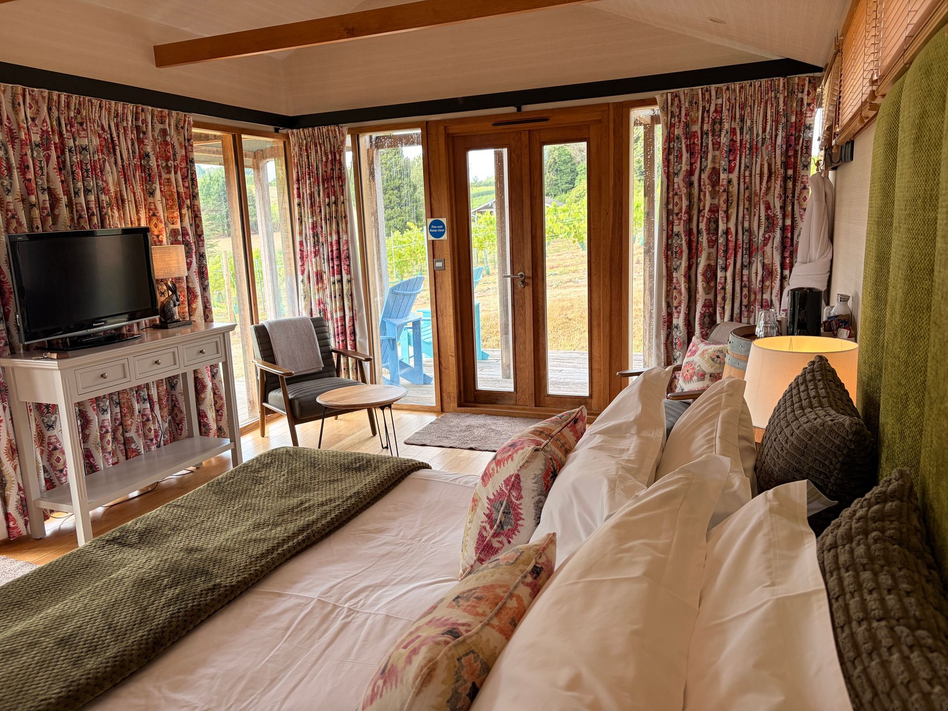a bedroom with a large bed and a television
