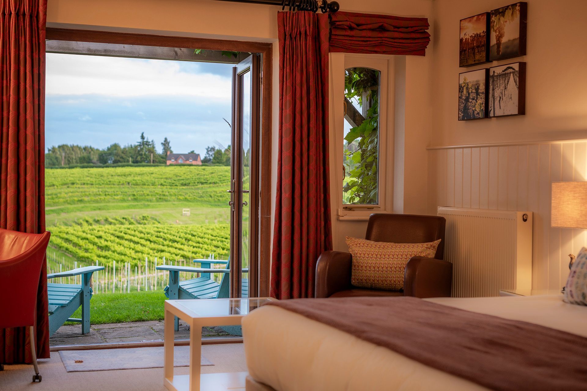 a bedroom with a large bed and a view of a vineyard
