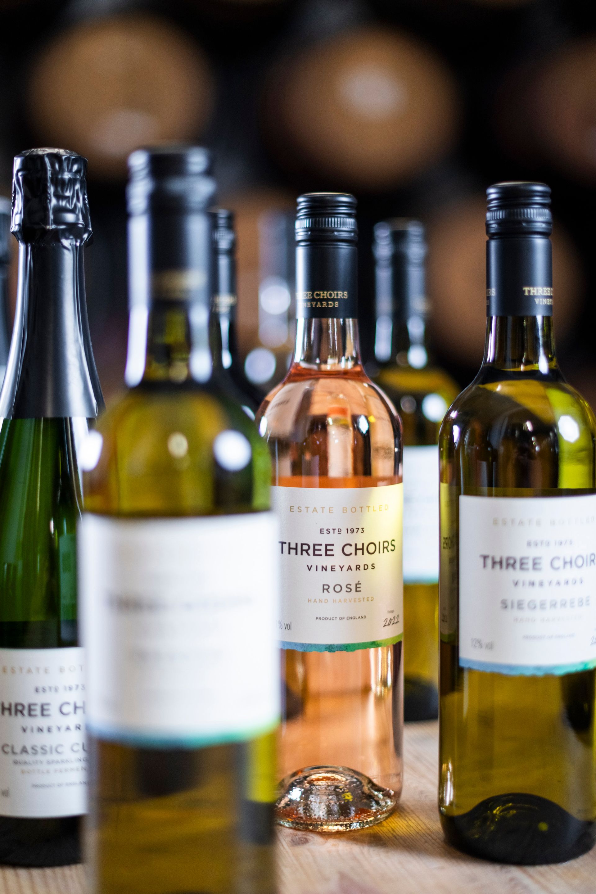 several bottles of three choirs wine are lined up on a table