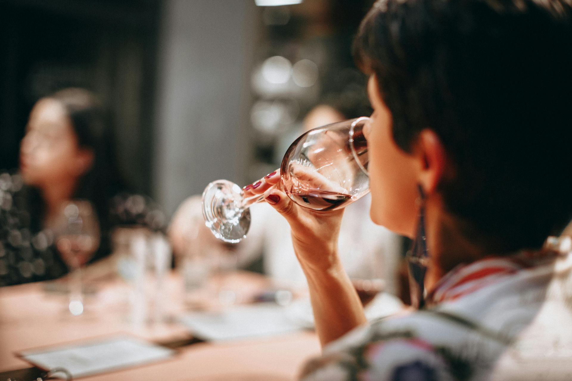 A lady sipping wine from a glass. Wine Tasting at Three Choirs Vineyard
