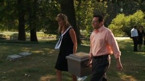 Couple Carrying Burial Vault