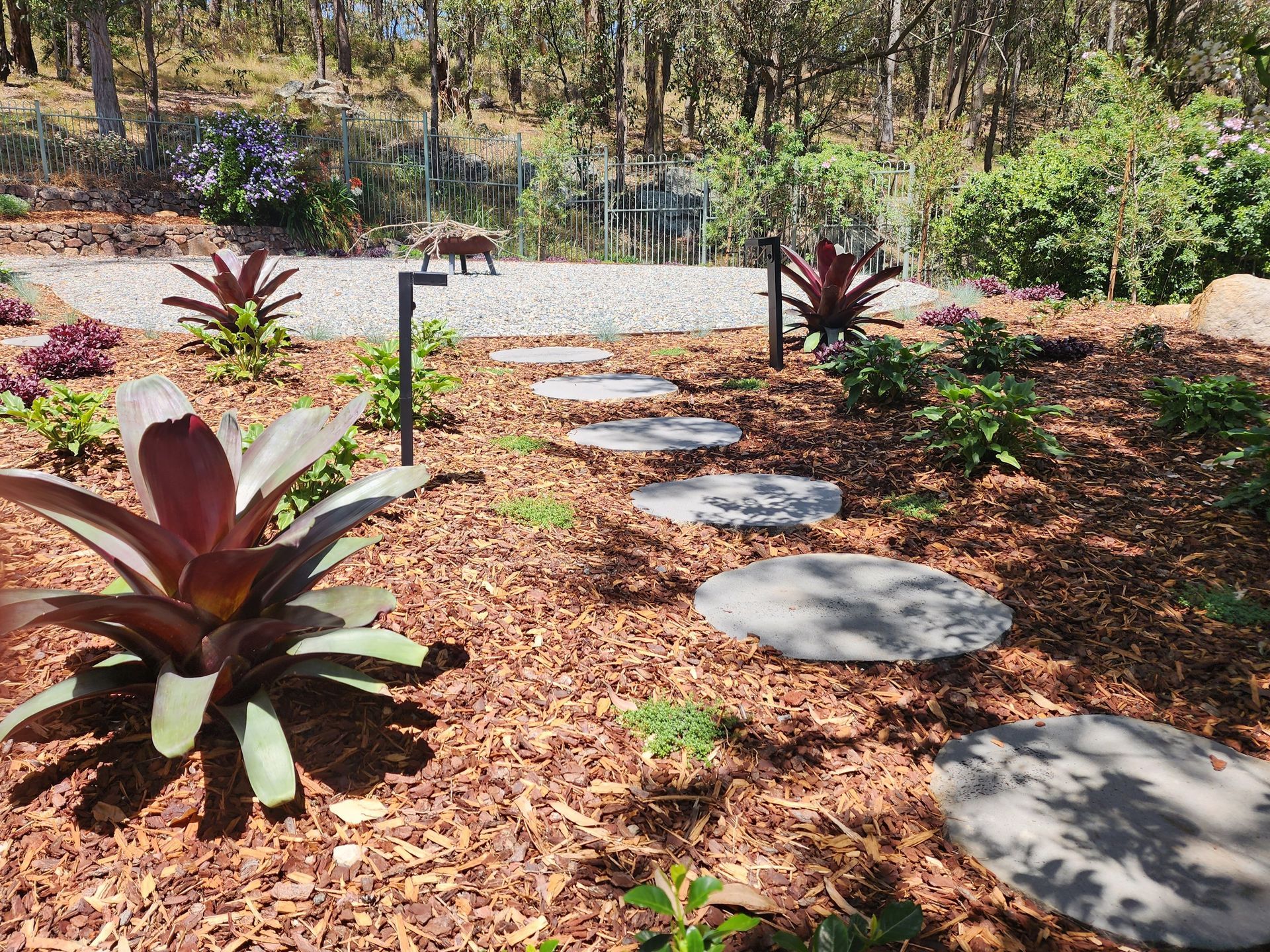 A Walkway And Potted Plants Along The Side Of A House — Green Envy Landscape & Garden Services In Cameron Park NSW