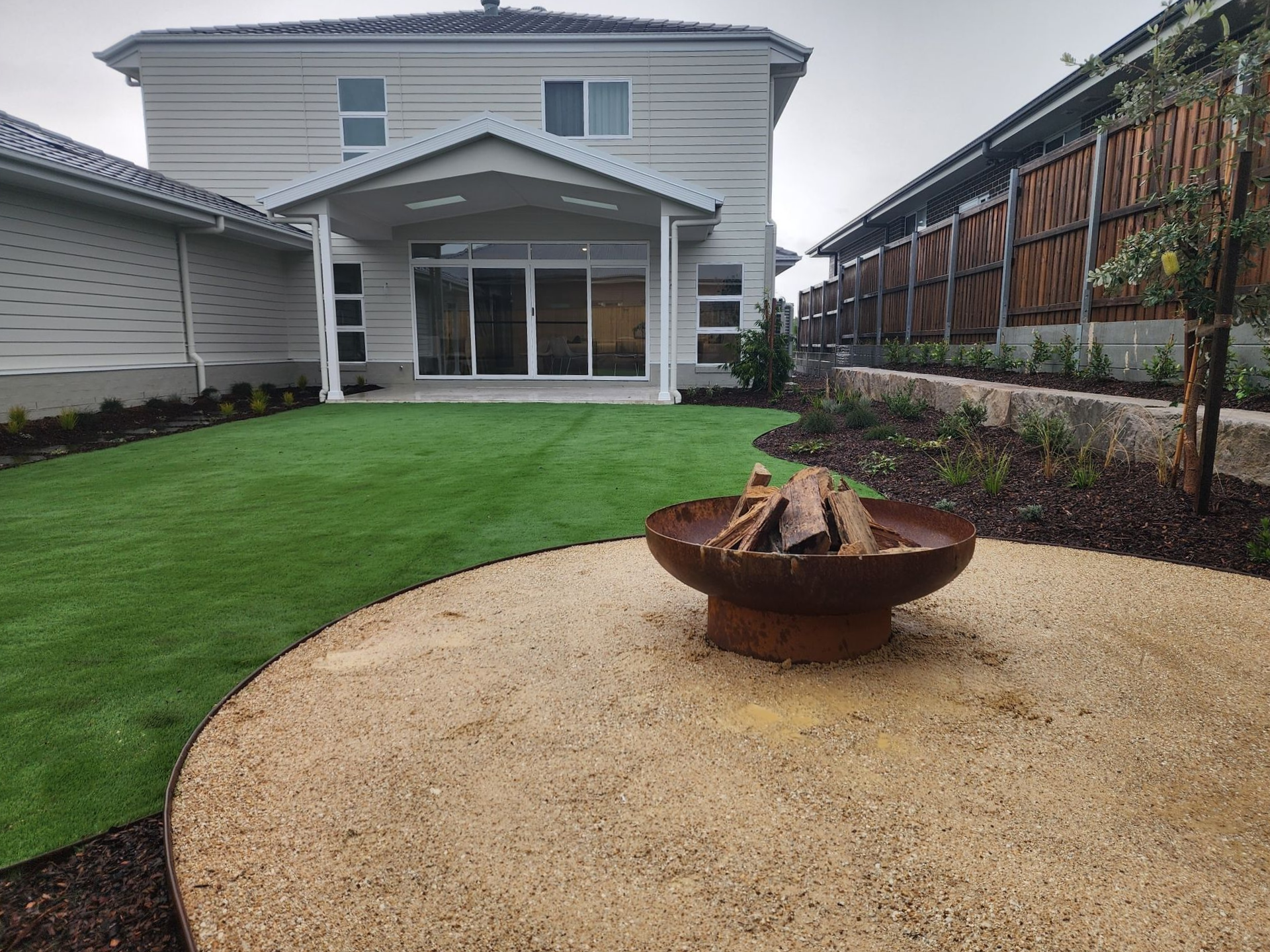 A House With A Large Lawn And A Bird Bath In Front Of It — Green Envy Landscape & Garden Services In Cameron Park NSW