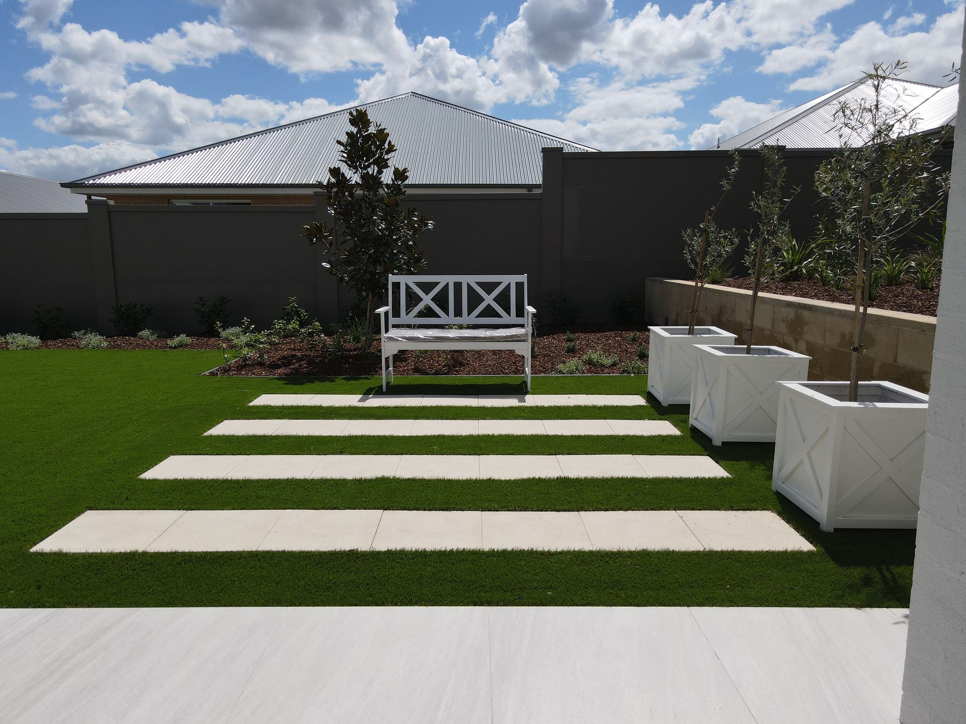 There Is A Swimming Pool In The Backyard With A Wooden Deck — Green Envy Landscape & Garden Services In Cameron Park NSW