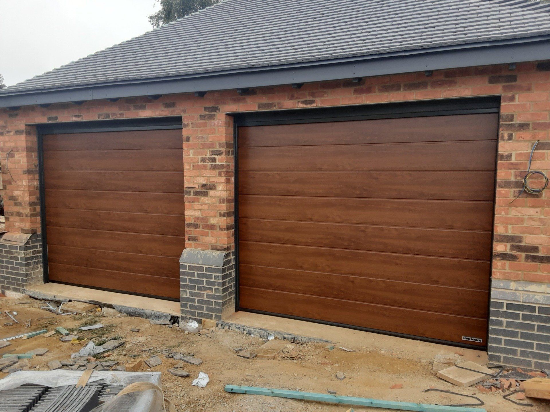 Twin sectional garage doors