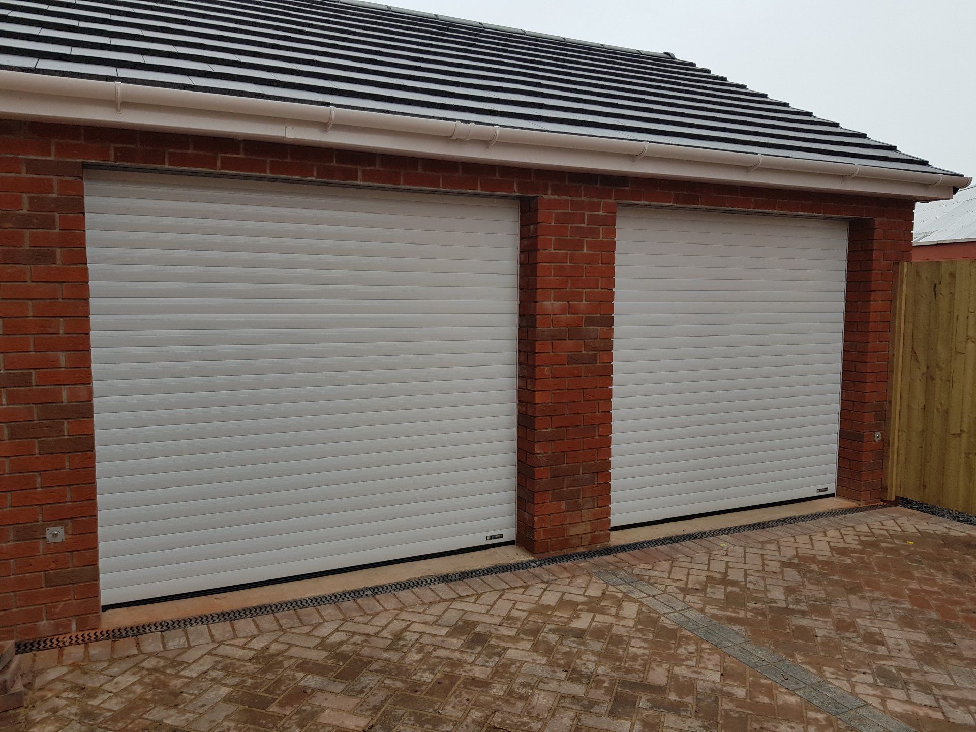 Twin white roller garage doors