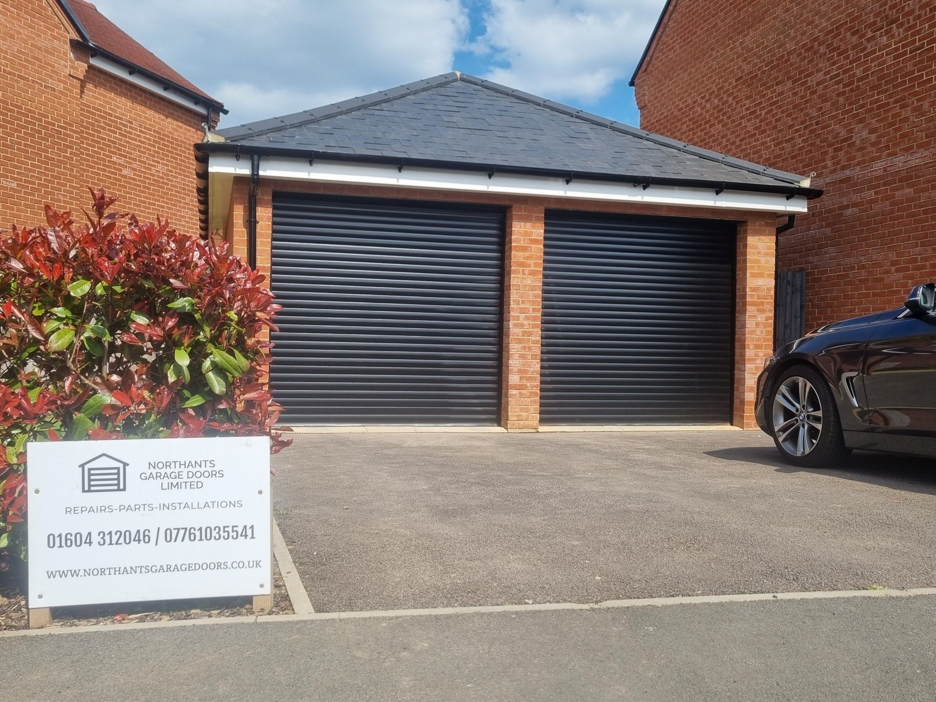 Twin black roller garage doors