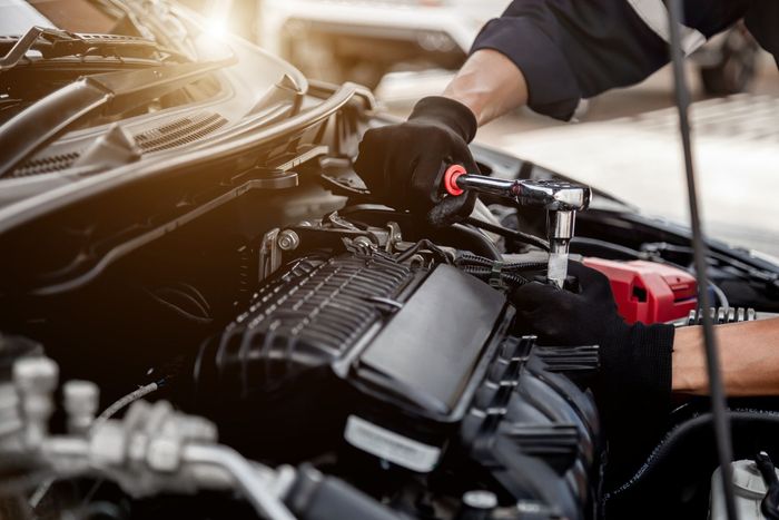 Man Is Working On A Car Engine — Metairie, LA — Bert's Auto Repair Man Is Working On A Car Engine — Metairie, LA — Bert's Auto Repair