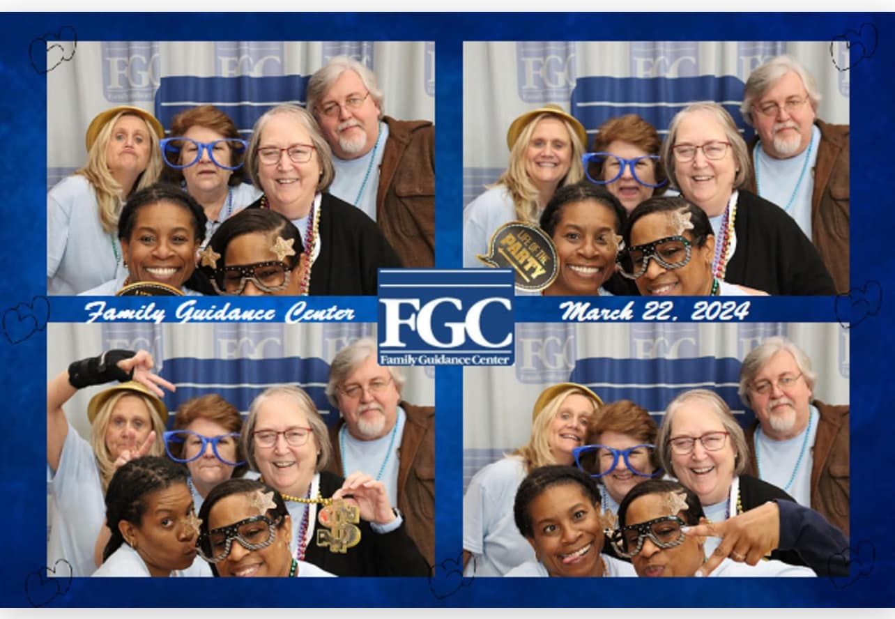 A group of people posing for a photo in a fgc photo booth