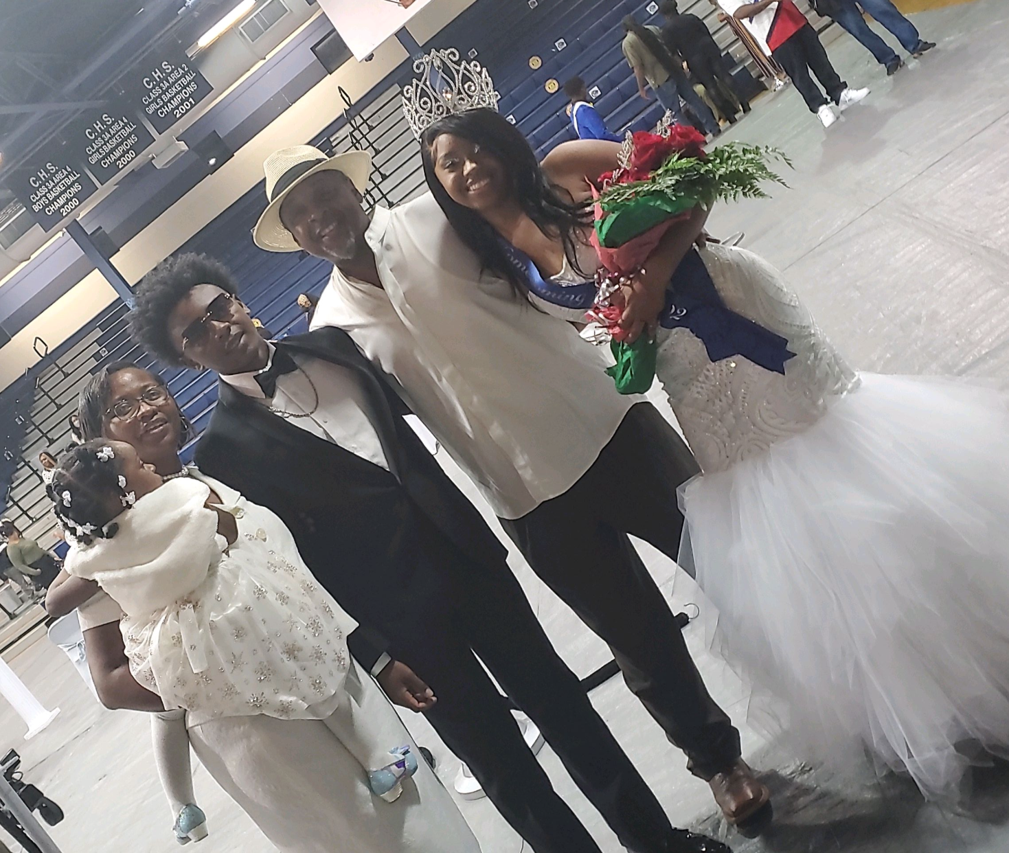 A group of people posing for a picture including a bride and groom