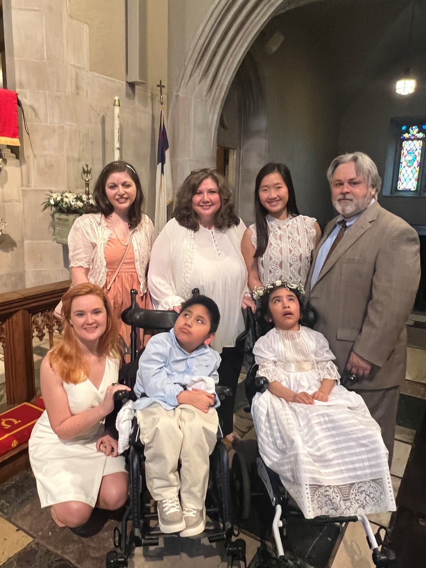 A group of people are posing for a picture in a church.
