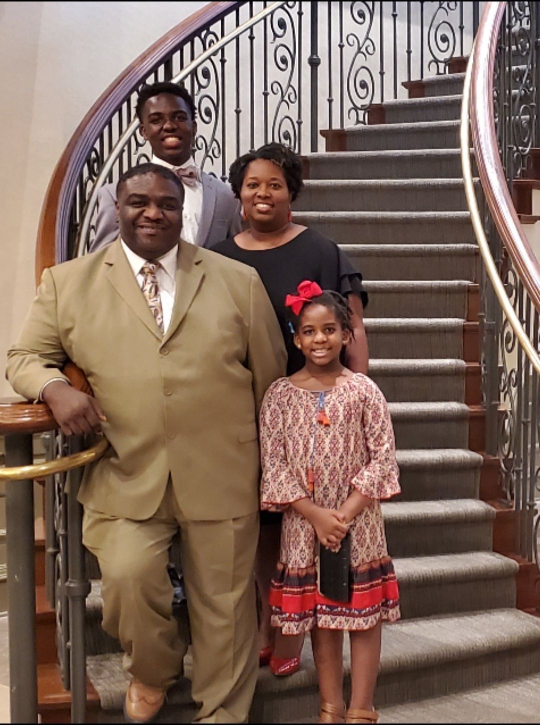 A family posing for a picture on a set of stairs