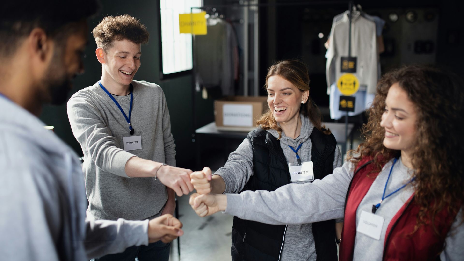 A group of people are putting their hands together in a circle.