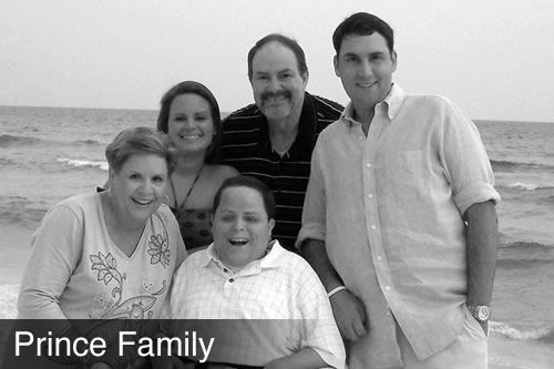 A black and white photo of the prince family on the beach