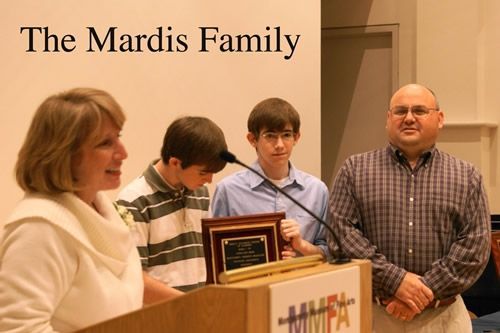 A group of people standing around a podium with the words