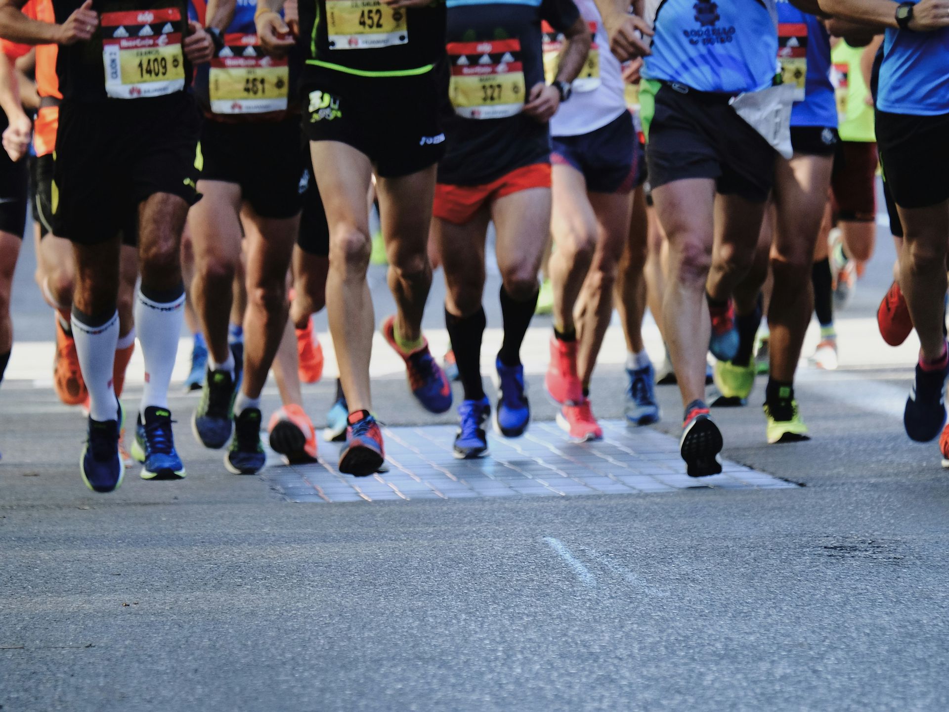 A group of people are running a marathon on a street.