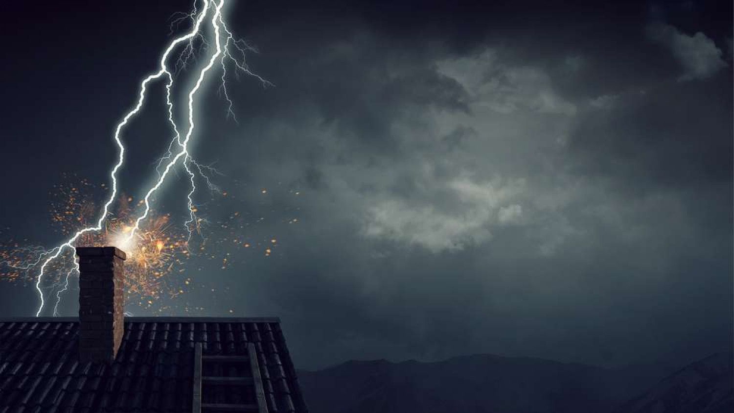 Lightning strikes a chimney on a house roof under a dark, stormy sky.