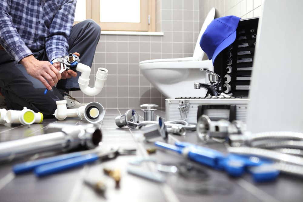 plumber at work in a bathroom