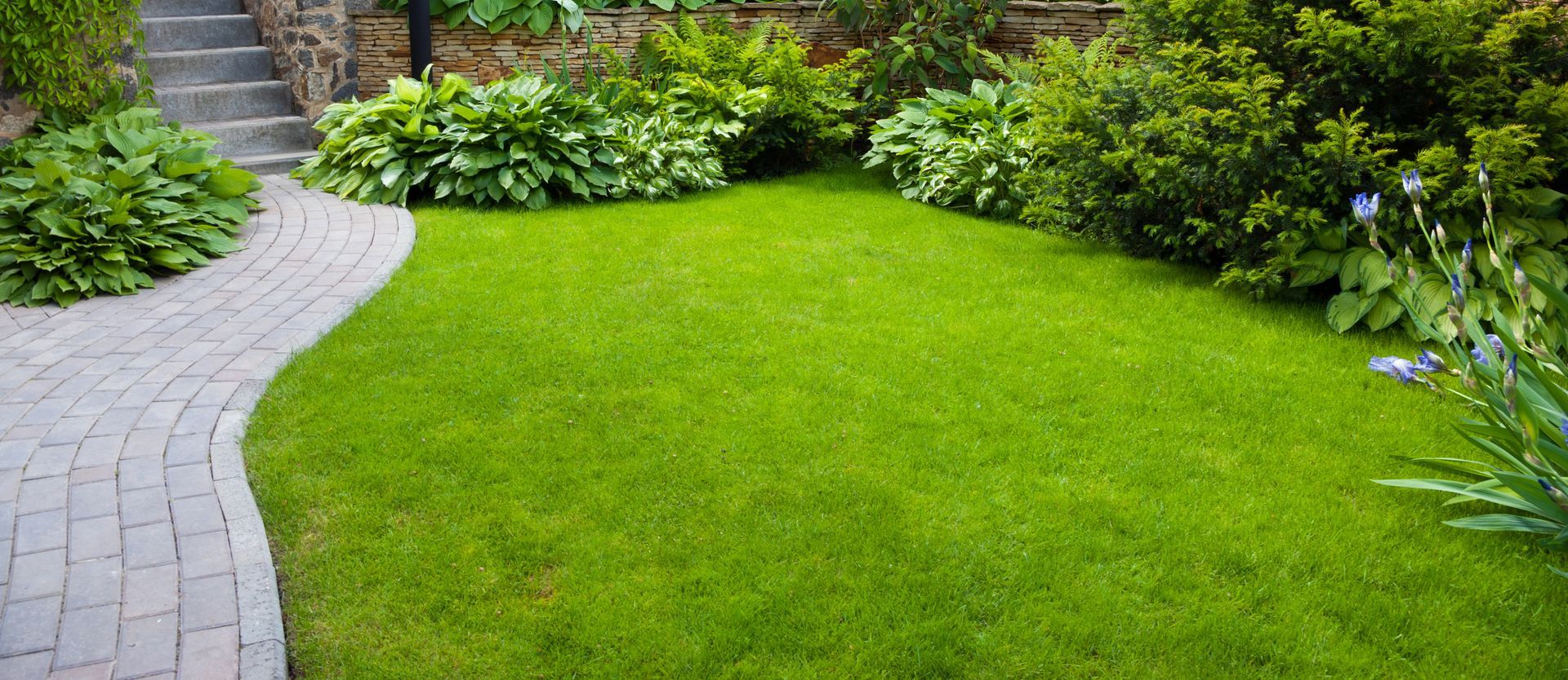 Landscaped backyard with stone patio