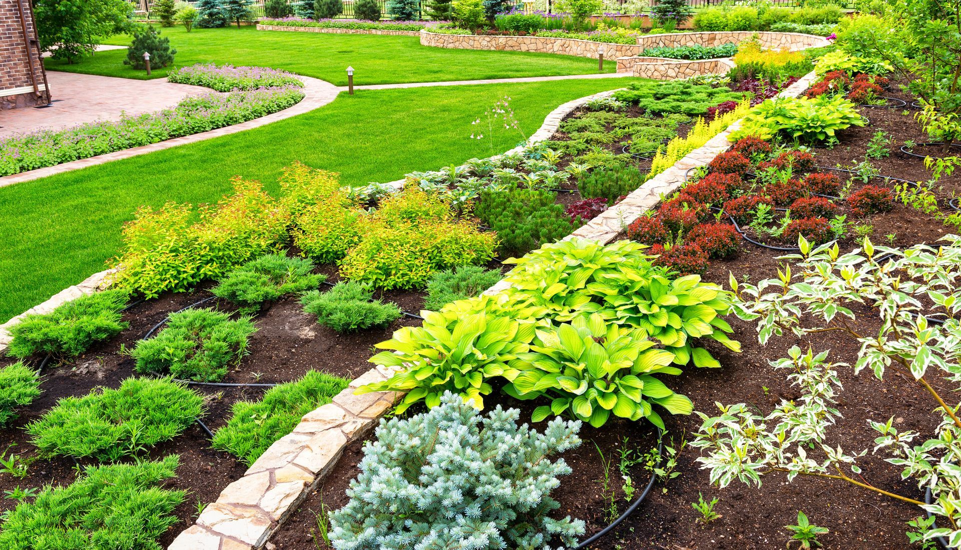 Landscaped backyard with stone patio