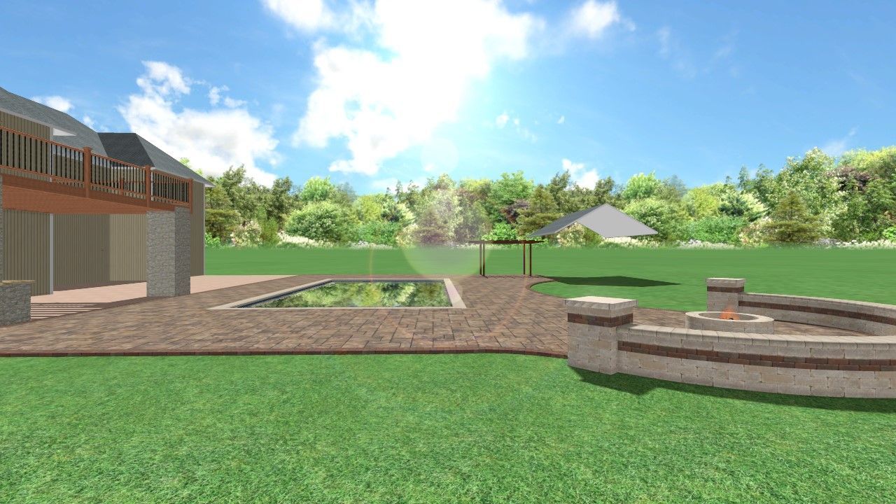 Sunny park with a brick patio, stone seating, green lawn, trees, and a building in the background