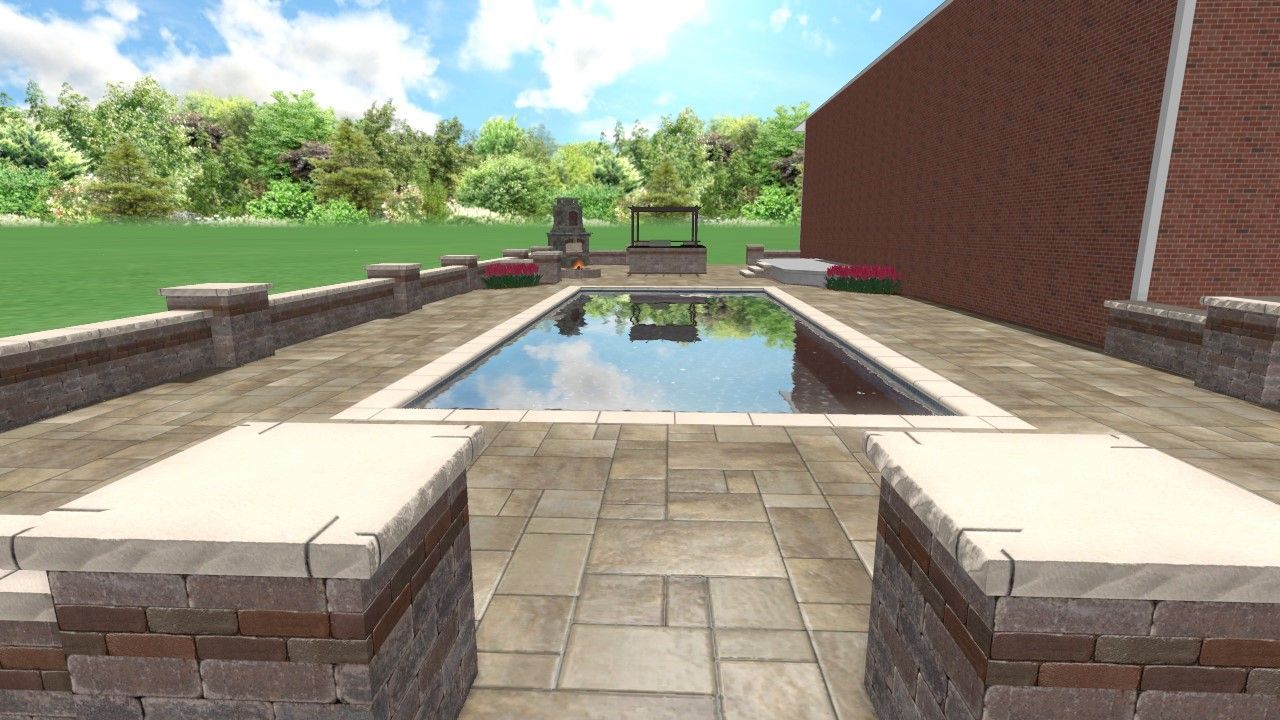 Patio with a rectangular reflecting pool, stone walkway, and lawn beside a red brick house
