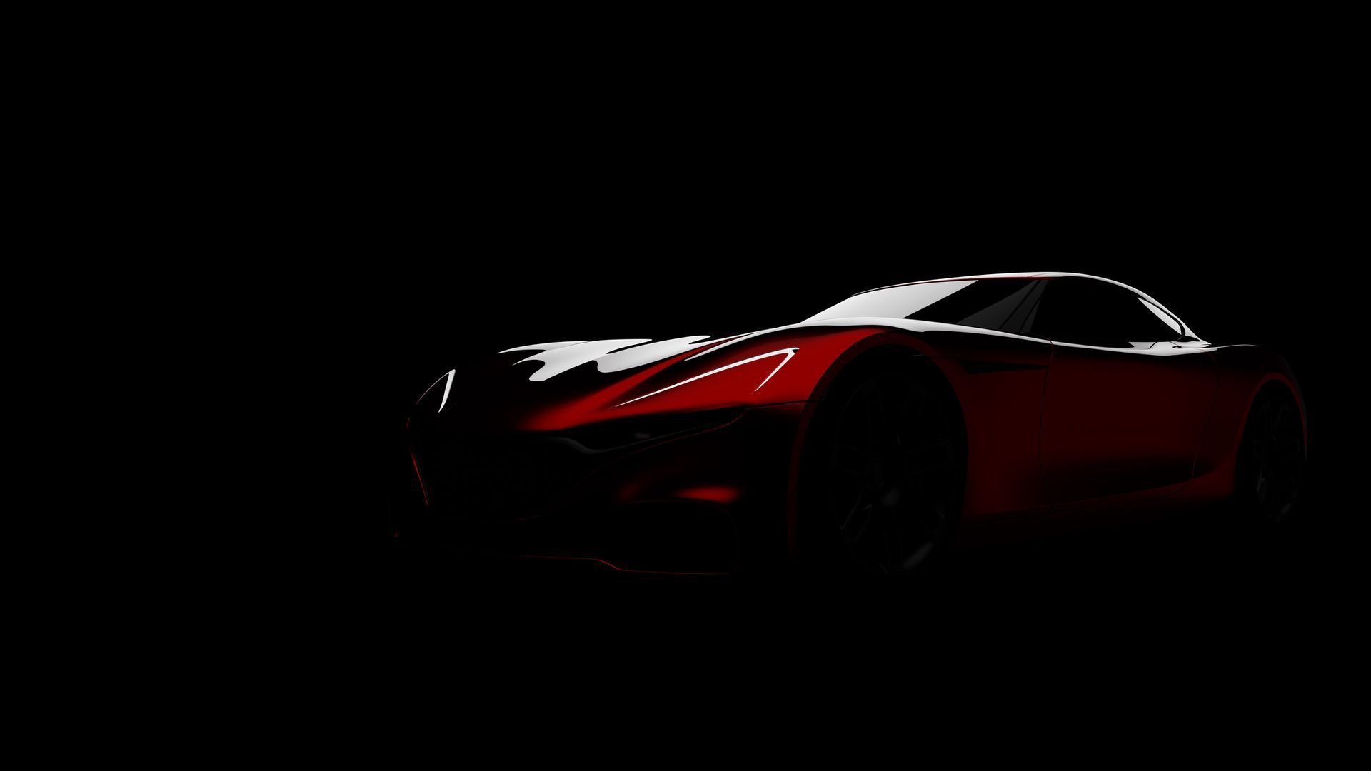 Red sports car, lit from the front, against a black background.