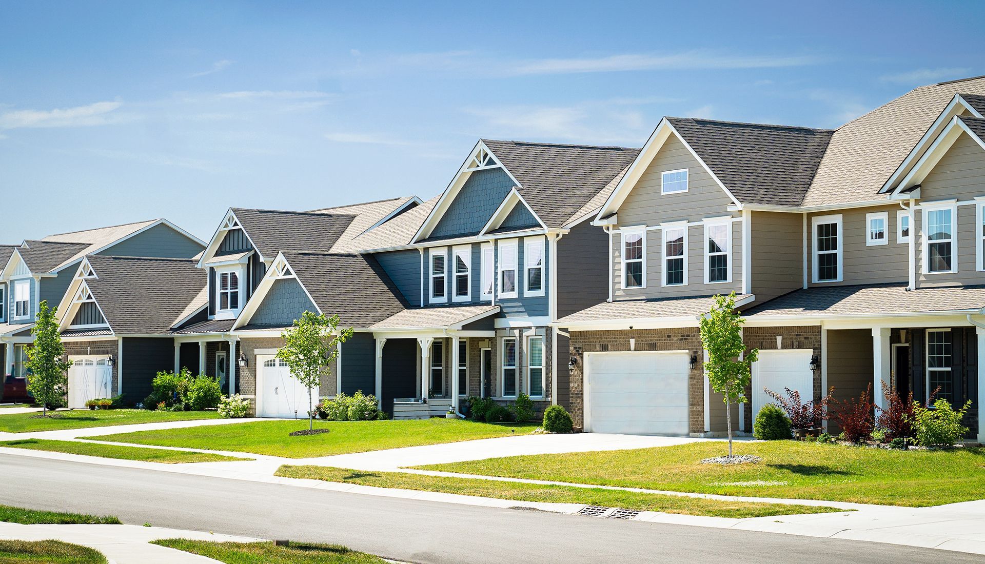 A row of houses in a residential neighborhood on a sunny day.
