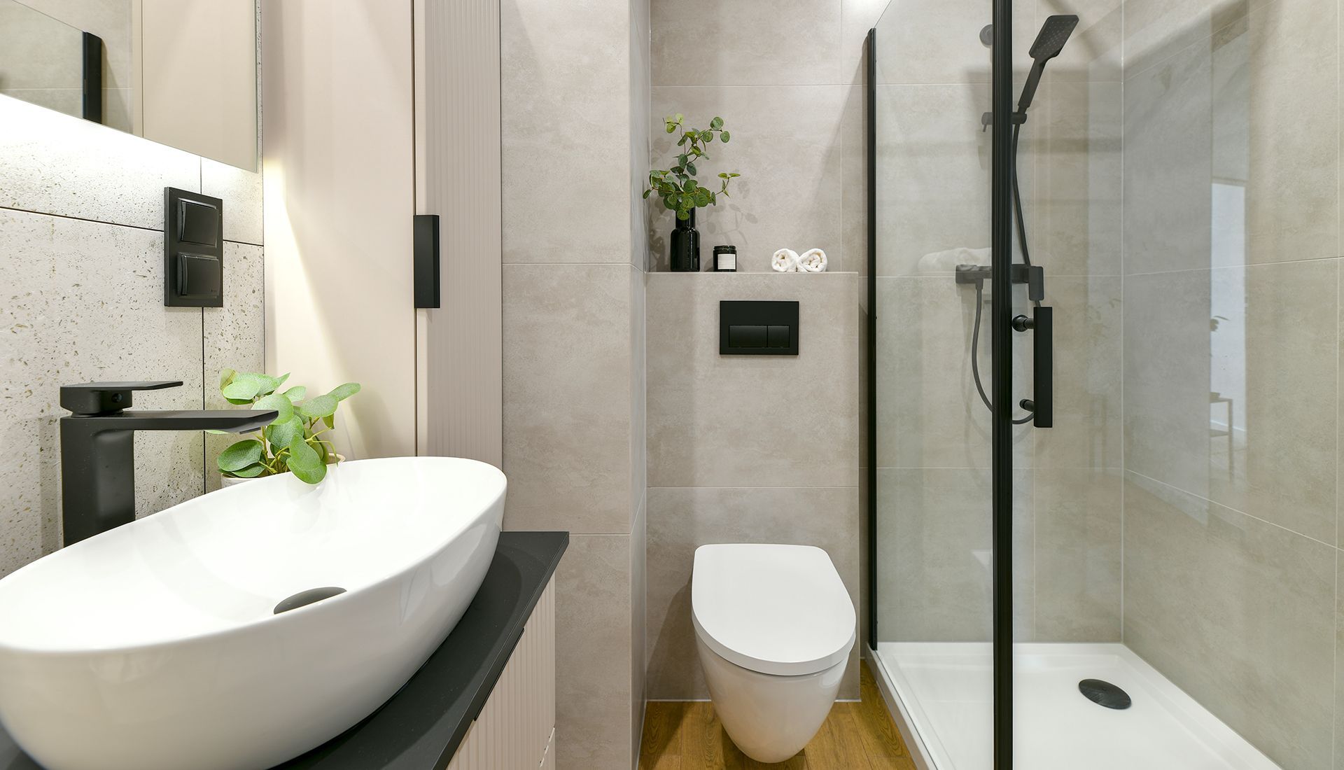 A bathroom with a sink , toilet , shower and mirror.