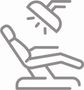 a person is sitting in a dental chair with a light on their head .