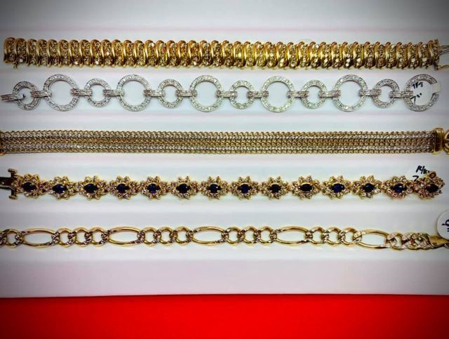 Several bracelets are lined up on a red surface