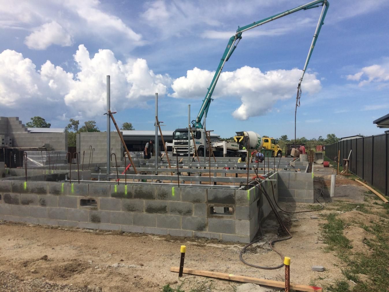 A Concrete Pump Is Being Used To Pour Concrete Into A Building — Sven Margraf Constructions Pty Ltd In Atherton QLD