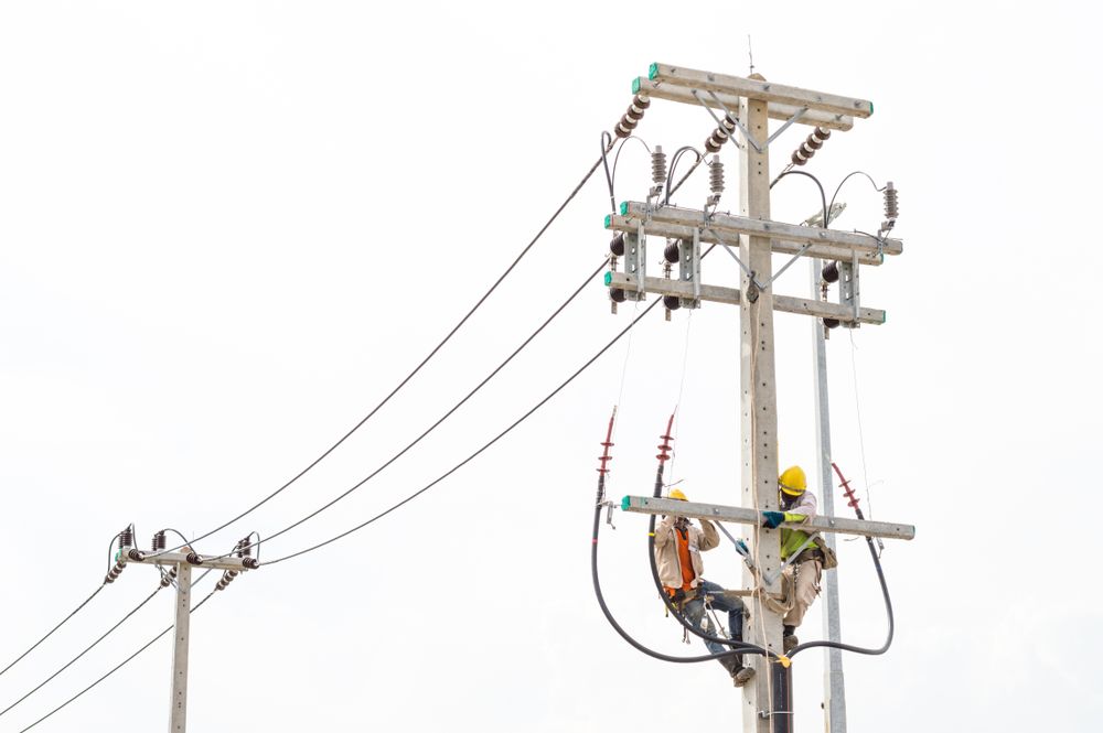 Two Electricians Are Working On A Power Pole — Connect Mid Coast Electrical Services In Taree, NSW
