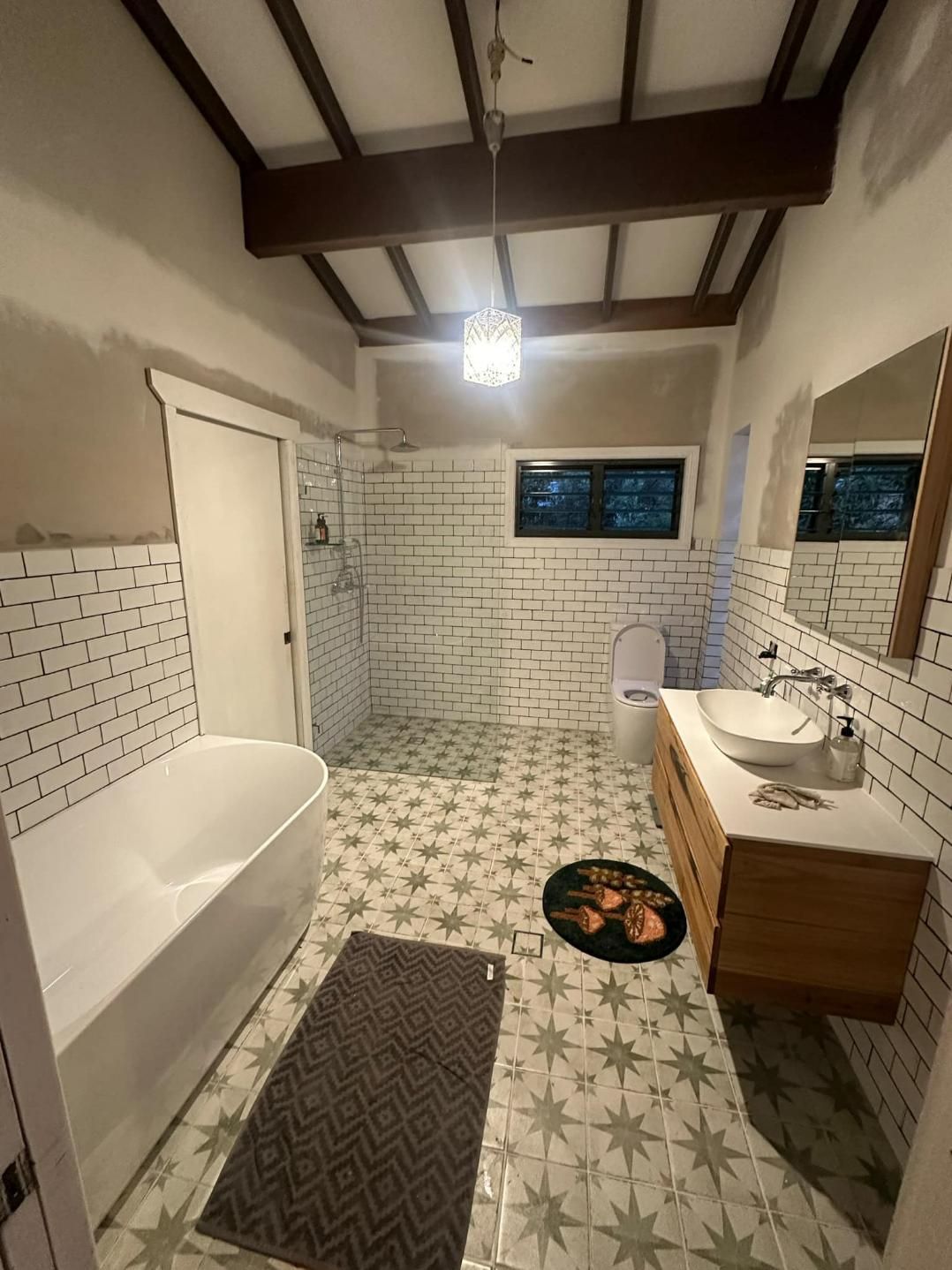 A Bathroom With A Bathtub , Sink , Toilet And Mirror — Connect Mid Coast Electrical Services In Taree, NSW
