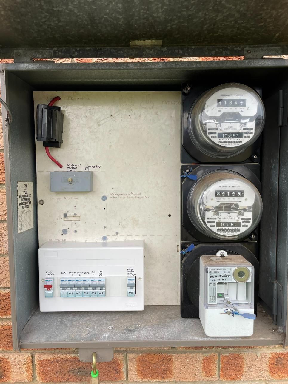 A Box With Three Electrical Meters Inside Of It On A Brick Wall — Connect Mid Coast Electrical Services In Taree, NSW