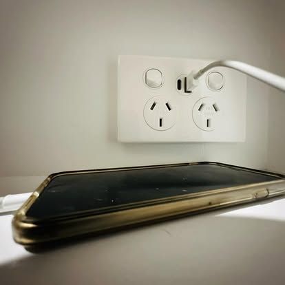 An Electrician Is Using A Multimeter To Test A Circuit Board — Connect Mid Coast Electrical Services In Taree, NSW