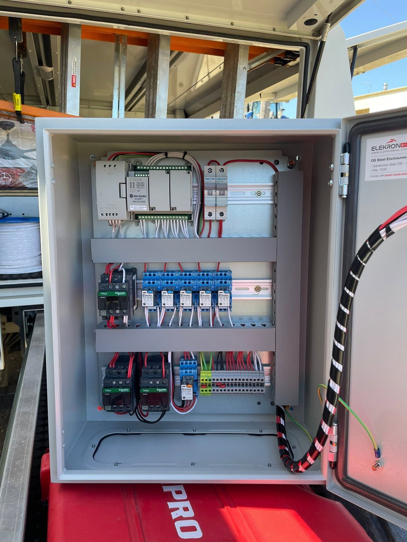 Open electrical control panel with wiring, breakers, and relays mounted inside a metal cabinet. — Connect Mid Coast Electrical Services In Taree, NSW