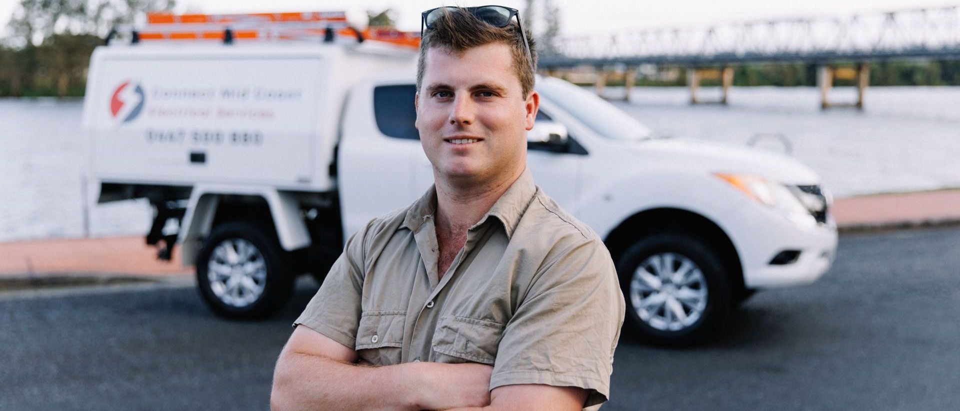 A Man In A Red Hat Is Working On A Security System — Connect Mid Coast Electrical Services In Taree, NSW