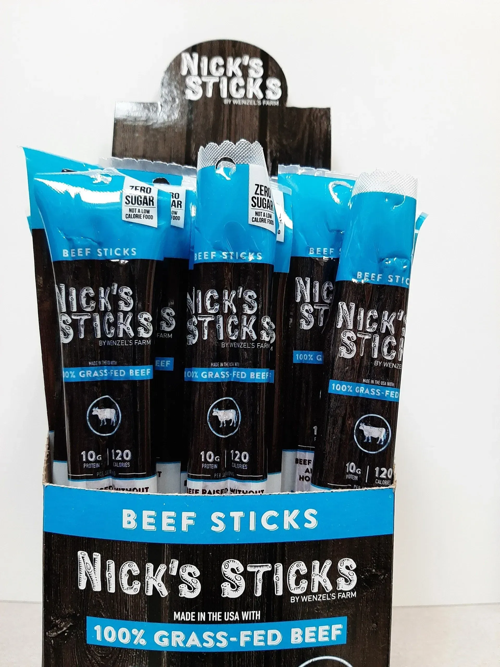 A cardboard display box filled with Nick's Sticks beef snack sticks, labeled