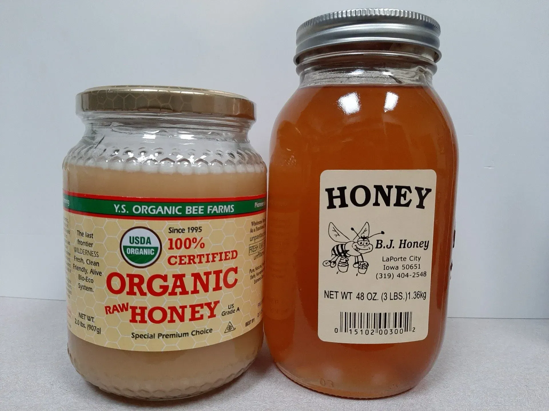 Two jars of honey side by side; the left is Y.S. Organic Bee Farms honey, the right is a jar labeled simply
