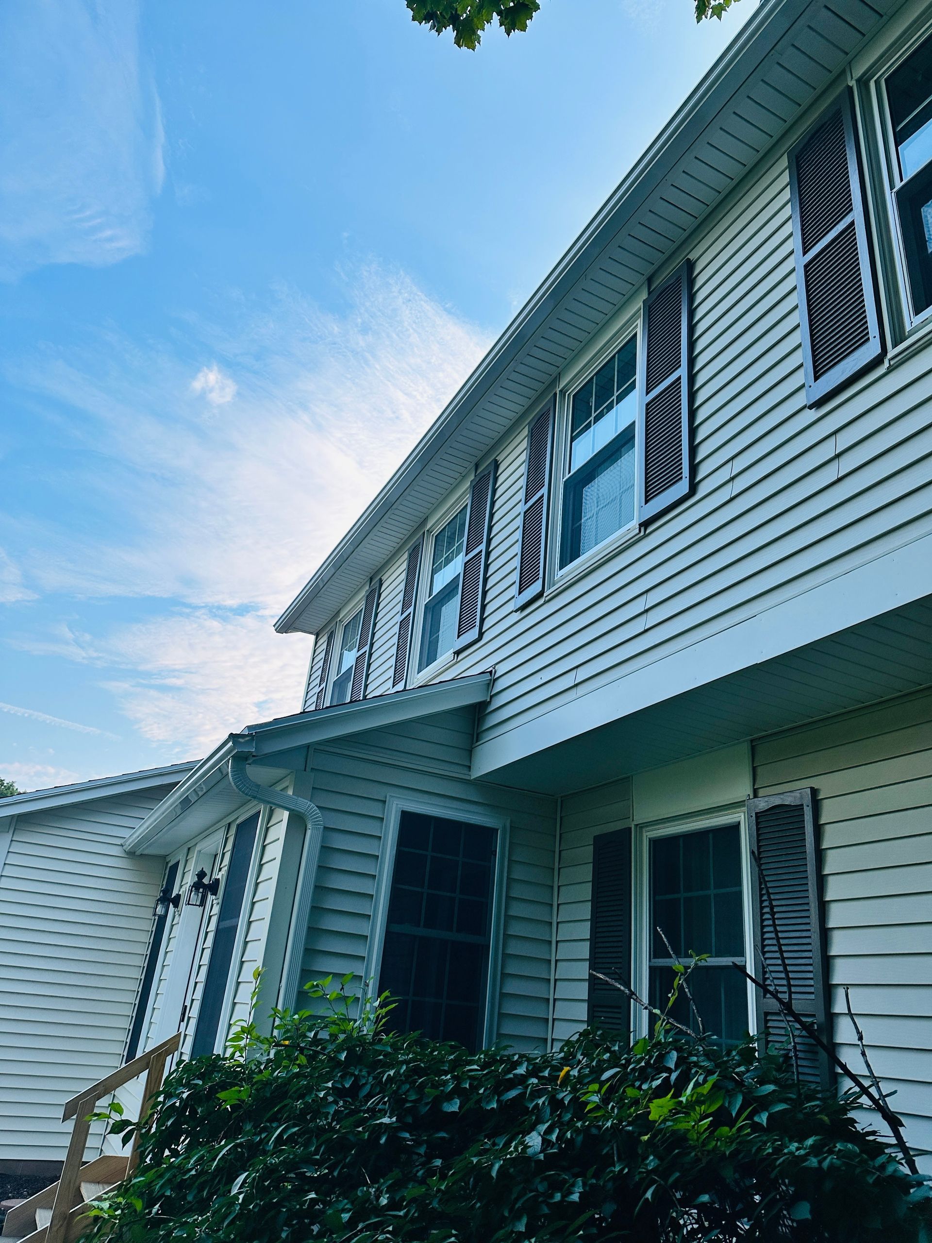 A two story house after a gutter replacement service is complete