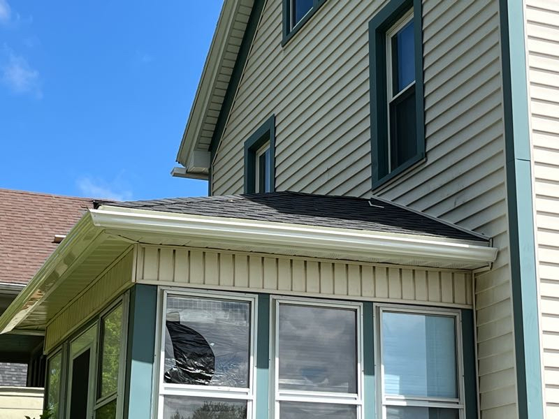 A new gutter system installed on yellow and black house
