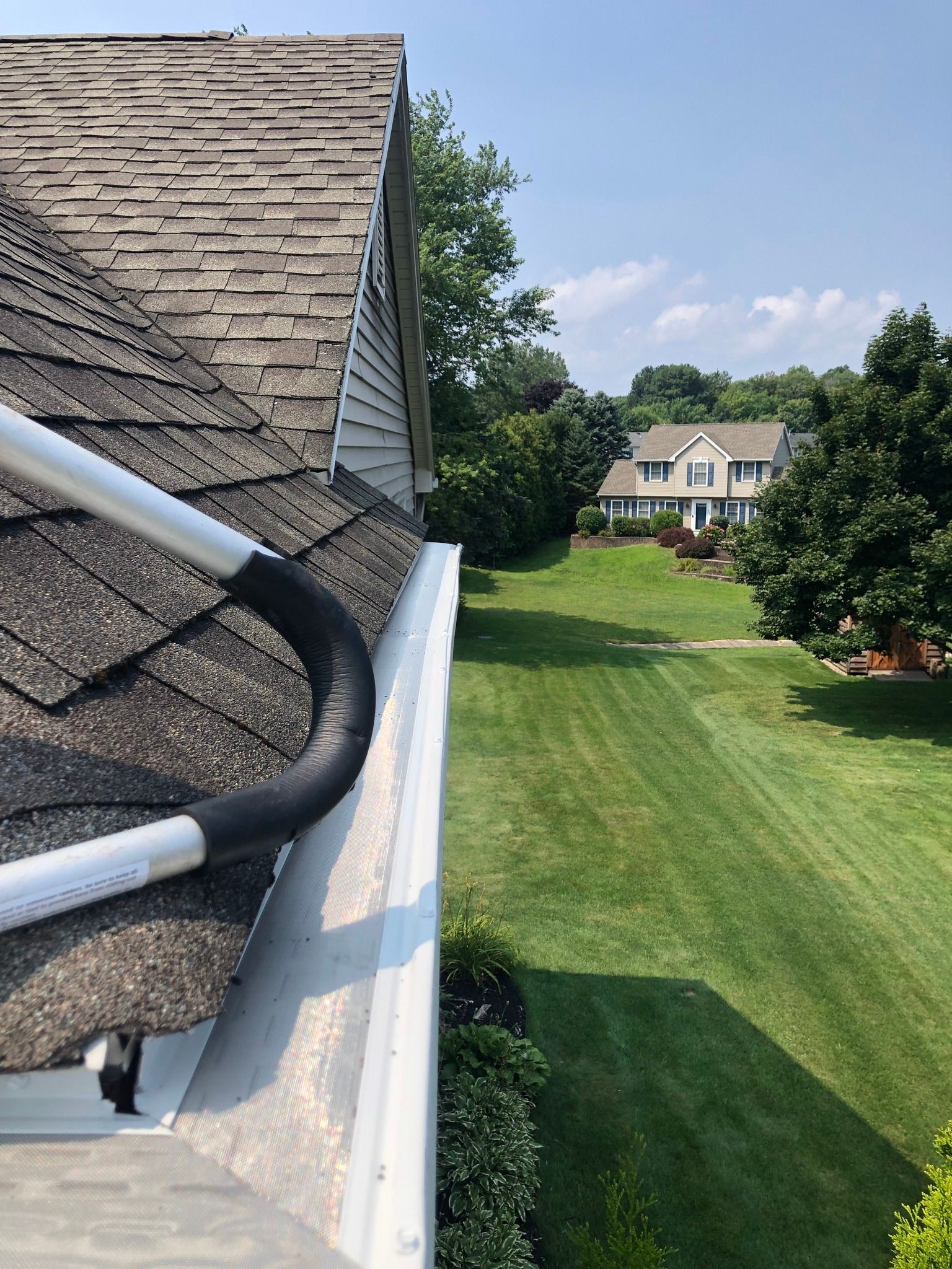 A recently finished gutter guard installation seen from above